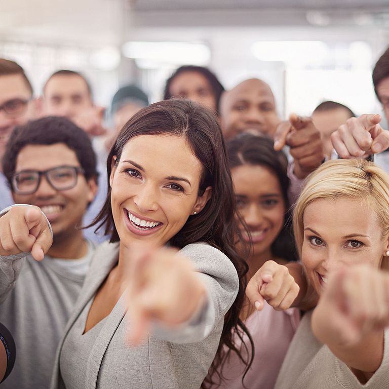Group of employees pointing at you